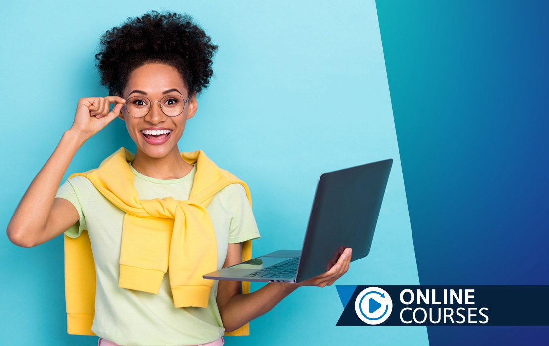 Woman with glasses holding a laptop.