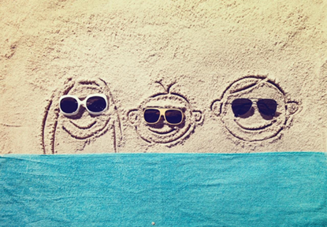 smiling faces in sand