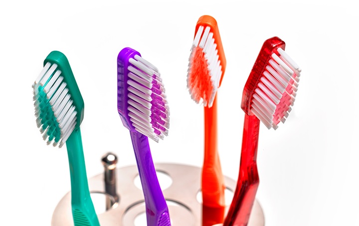 Top of toothbrush storage container with colorful toothbrushes displayed