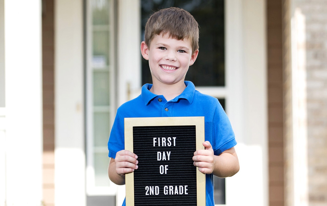 MouthHealthy Male child holding up back to school sign