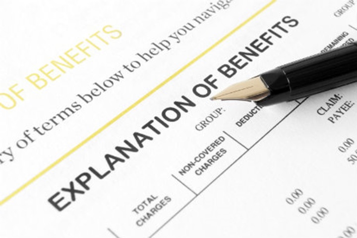 Explanation of benefits form with a pen.