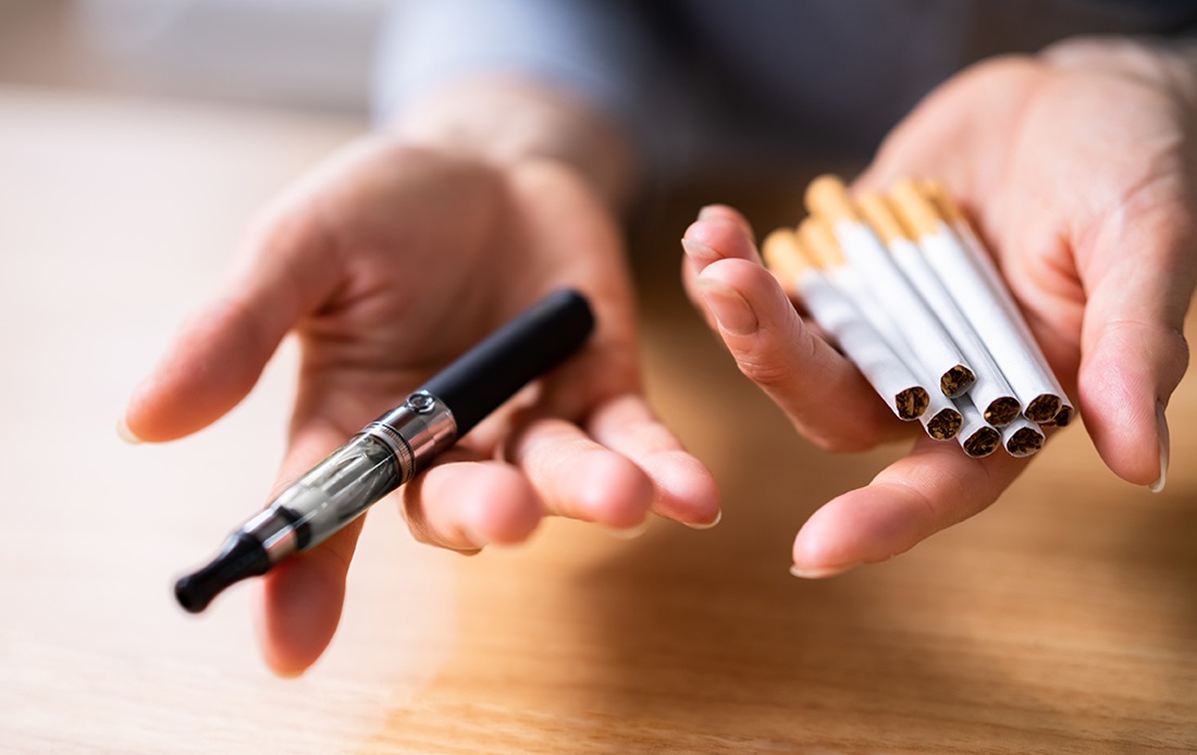 Person offering one vape or seven cigarettes