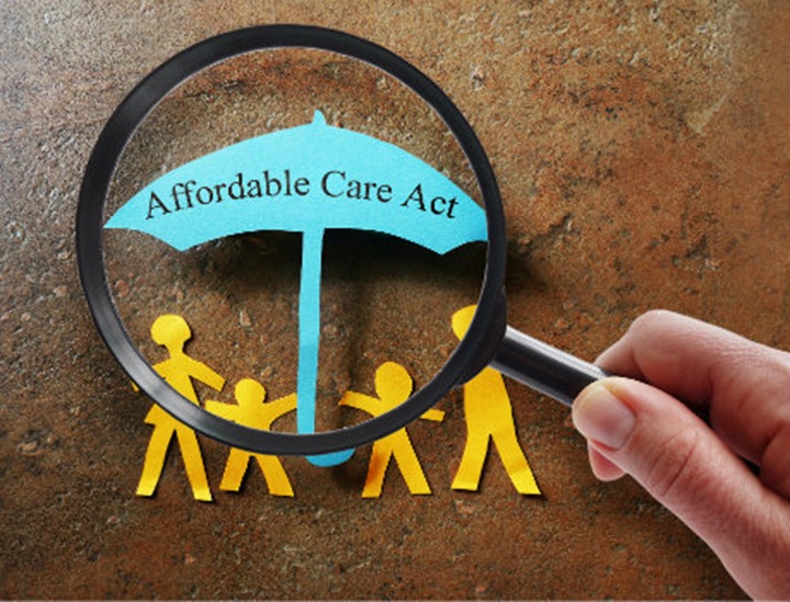 A paper cutout family under an Affordable Care Act umbrella.