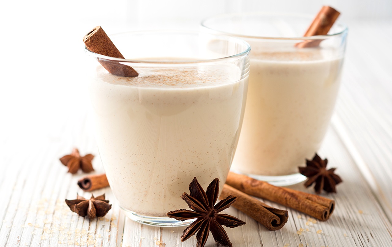 Mouthhealthy two glasses of holiday eggnog and cinnamon sticks