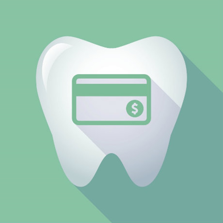 A tooth with a green credit card on a green background.
