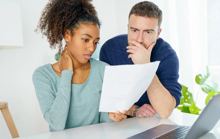 A man and woman looking over dental plan paperwork
