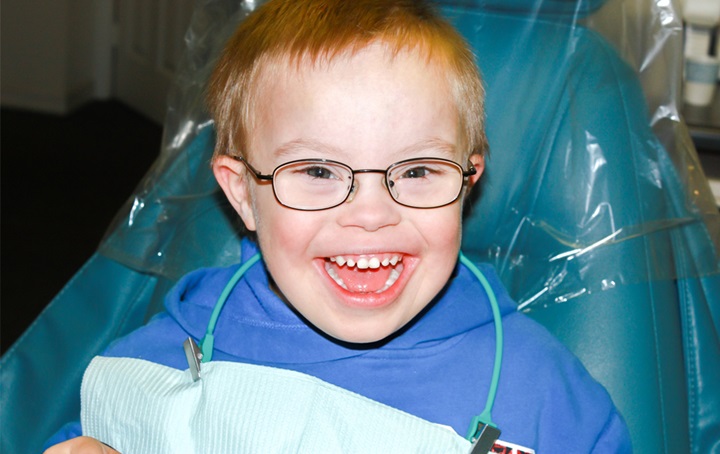 A young boy smiling while at the dentist.