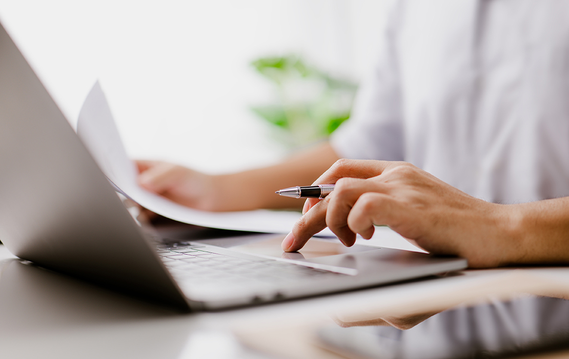 Man on laptop reviewing dental plans