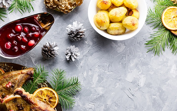 Thanksgiving table setting featuring cranberries and potatoes