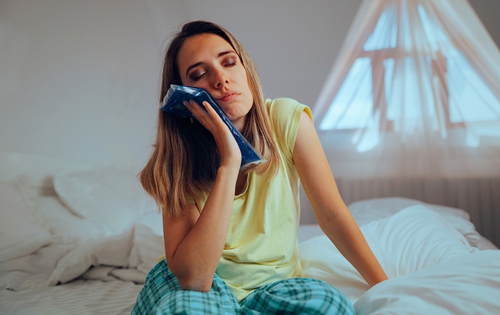 woman with ice pack on her jaw