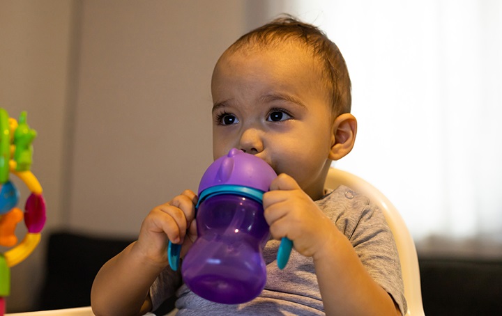 child with training cup