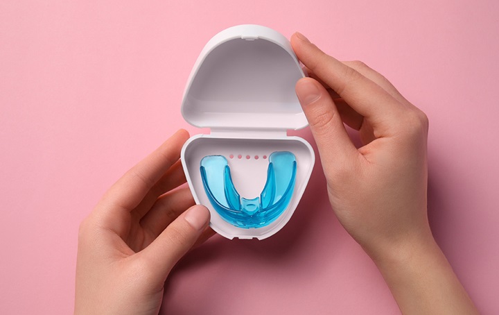 Someone holding open case with mouthguard