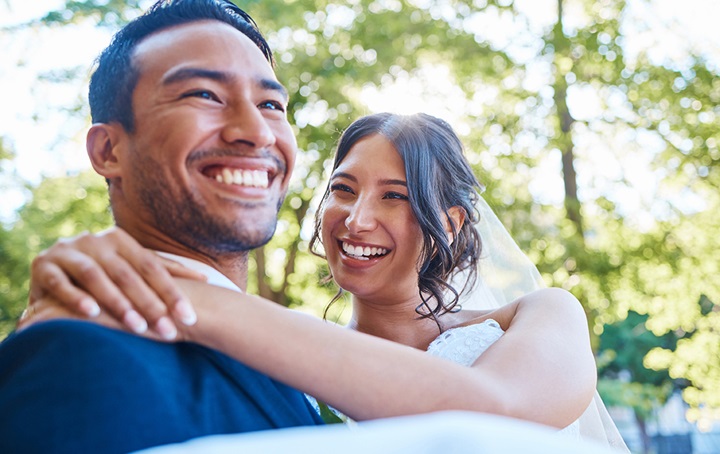 Groom carrying his bride