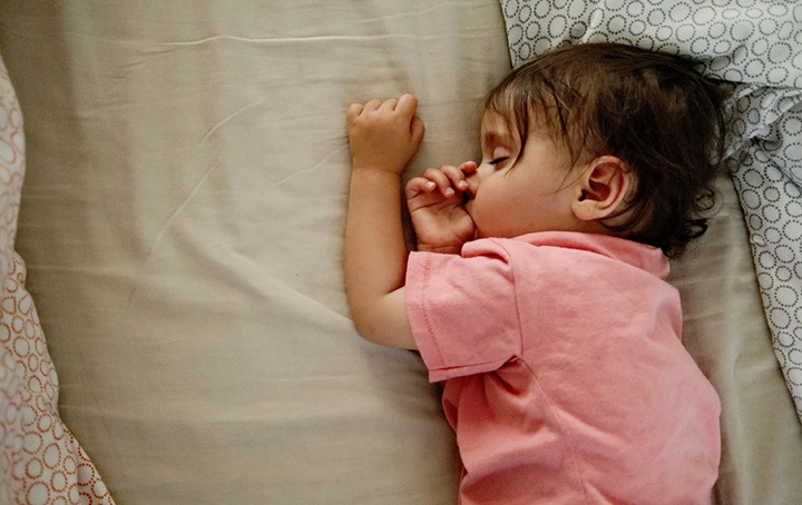 Baby sucking thumb while sleeping