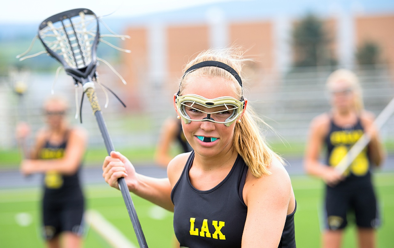 Teenage LaCrosse player with mouthgard and protective eyewear.
