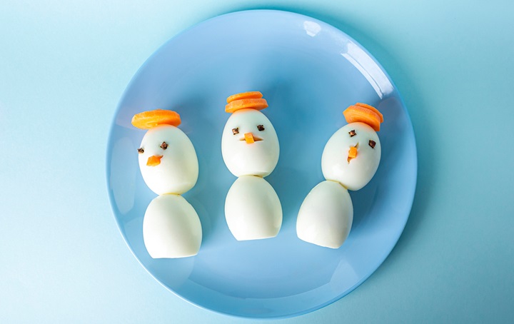 Three decorated snowmen on a plate