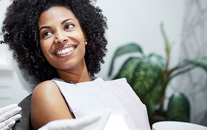 Patient in dental chair smiling