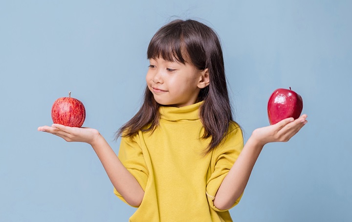 Girl holding apples