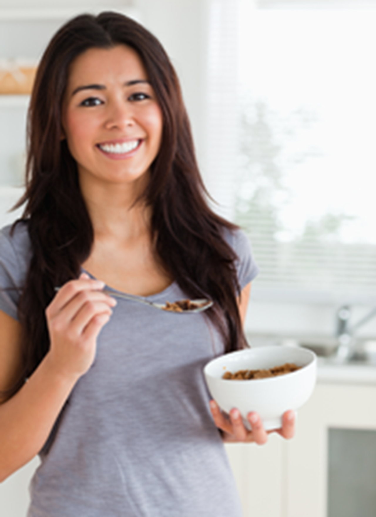 Image of young woman eating cereal