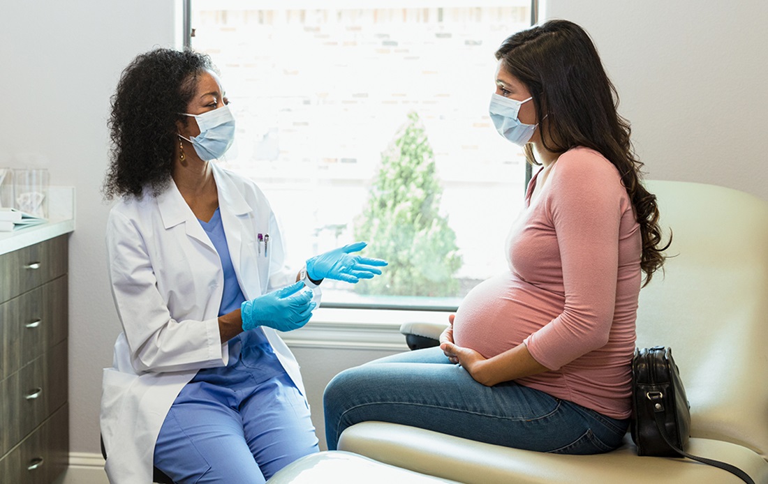 Image of dentist consulting with a pregnant patient