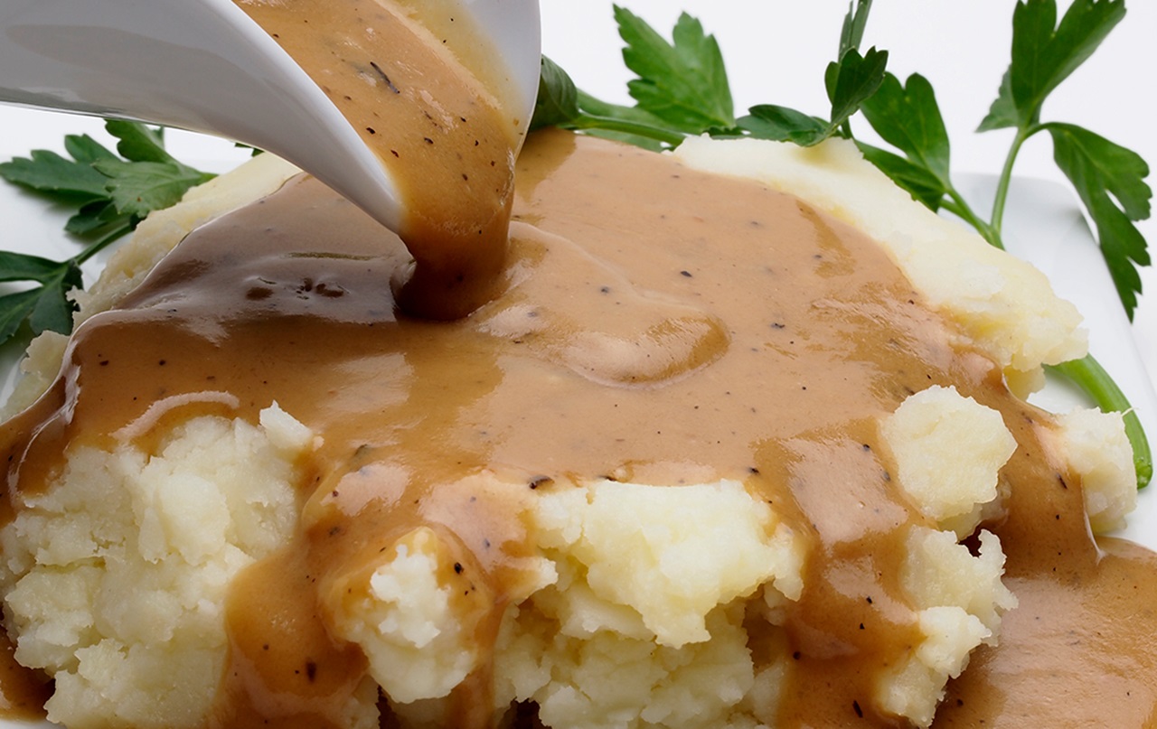 A photograph of mashed potatoes and gravy