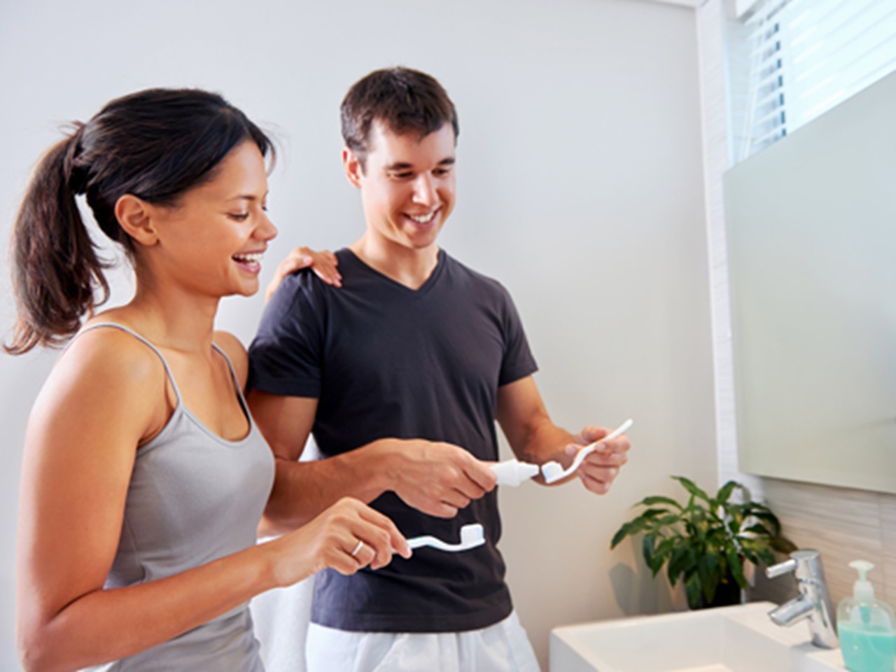 Couple brushing their teeth