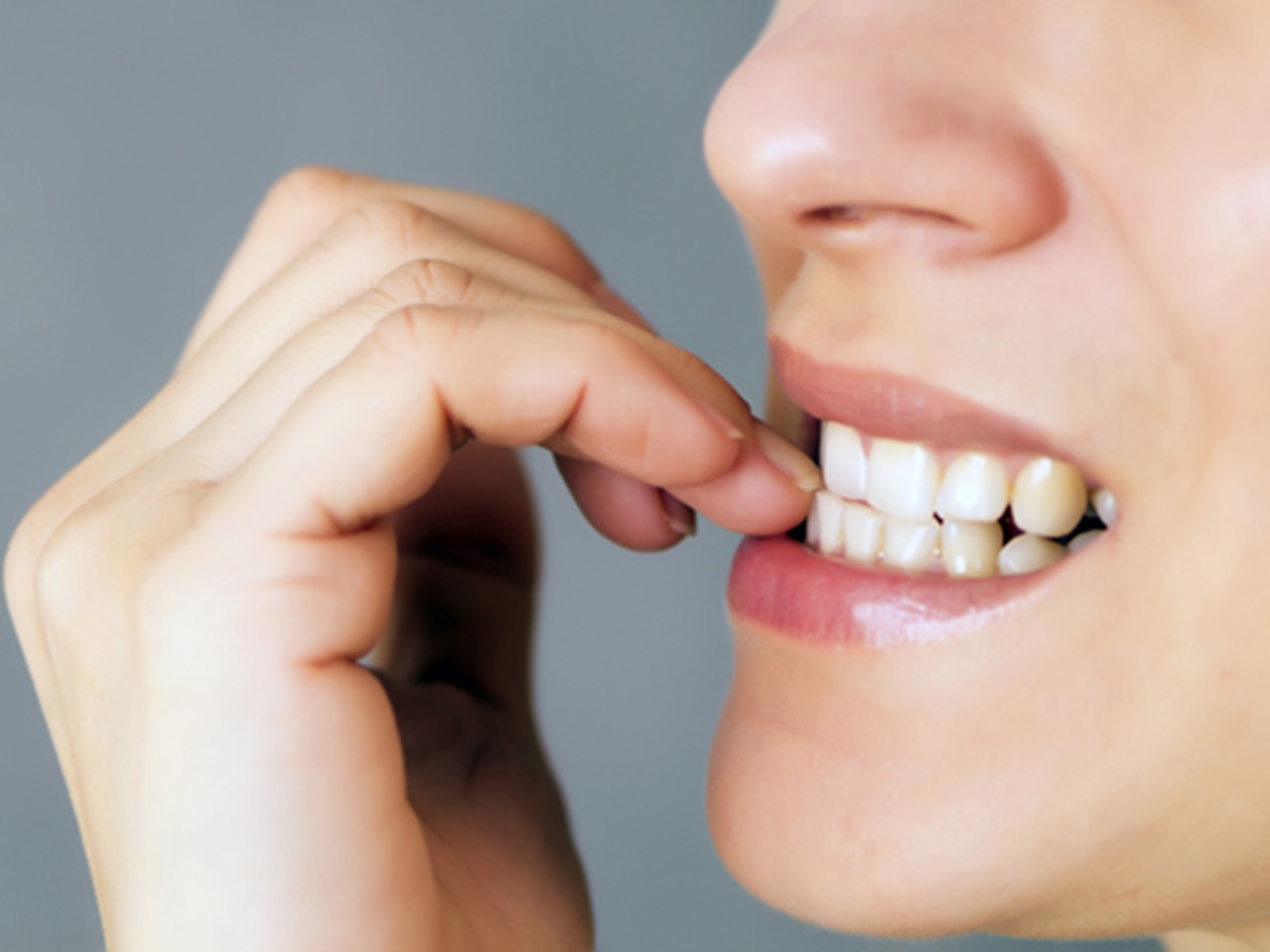 Woman biting nails