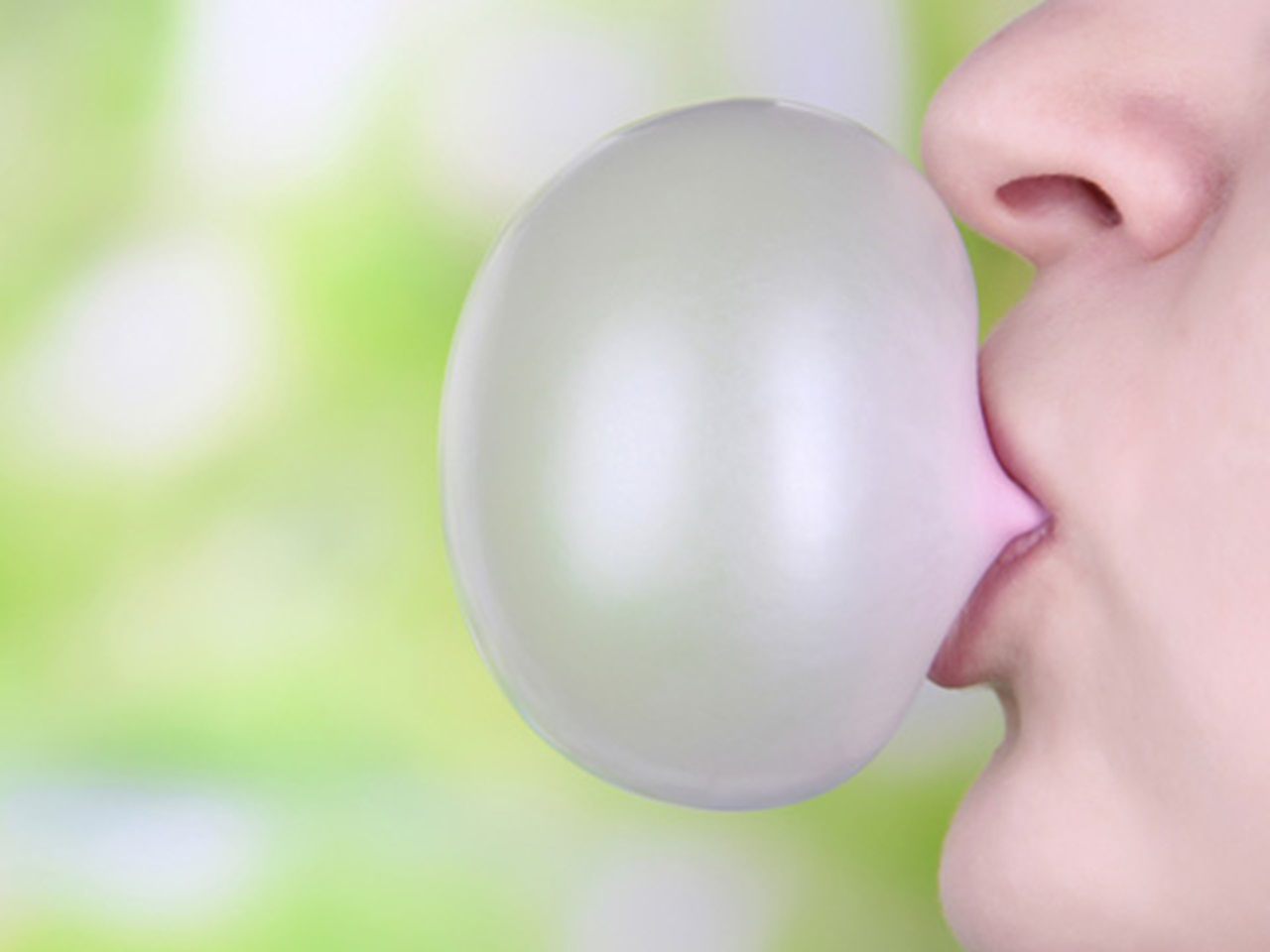 Woman blowing bubbles with gum